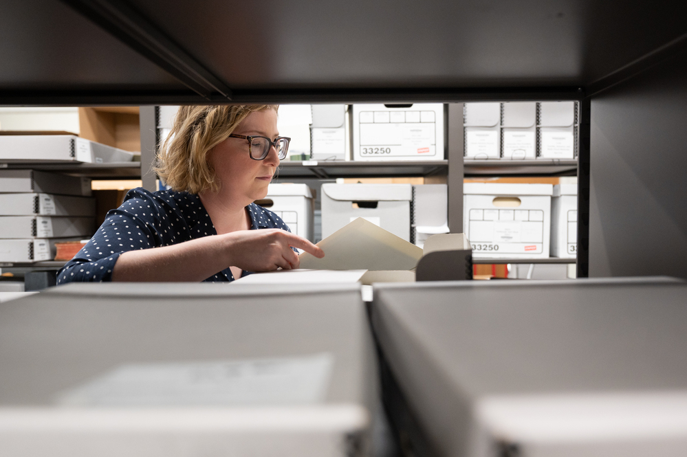 Librarian archivist among a bookshelf at Tech